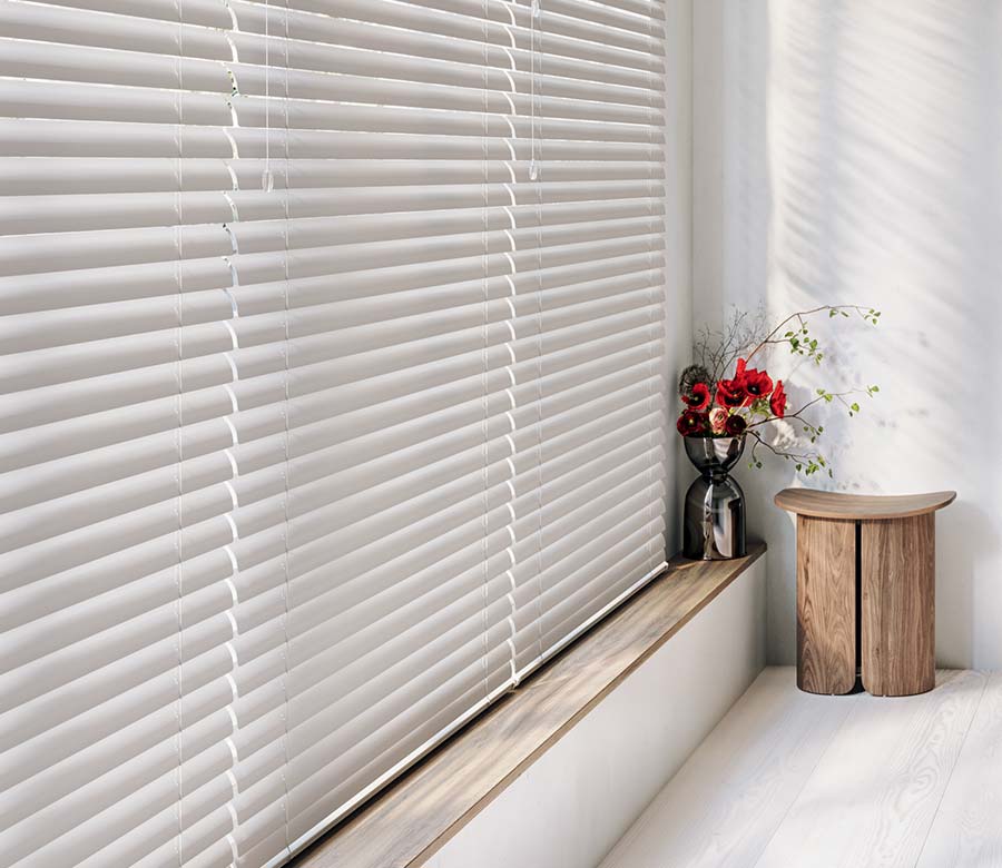 detail of large window covered by blinds in a soft white hue in Maple Grove, MN